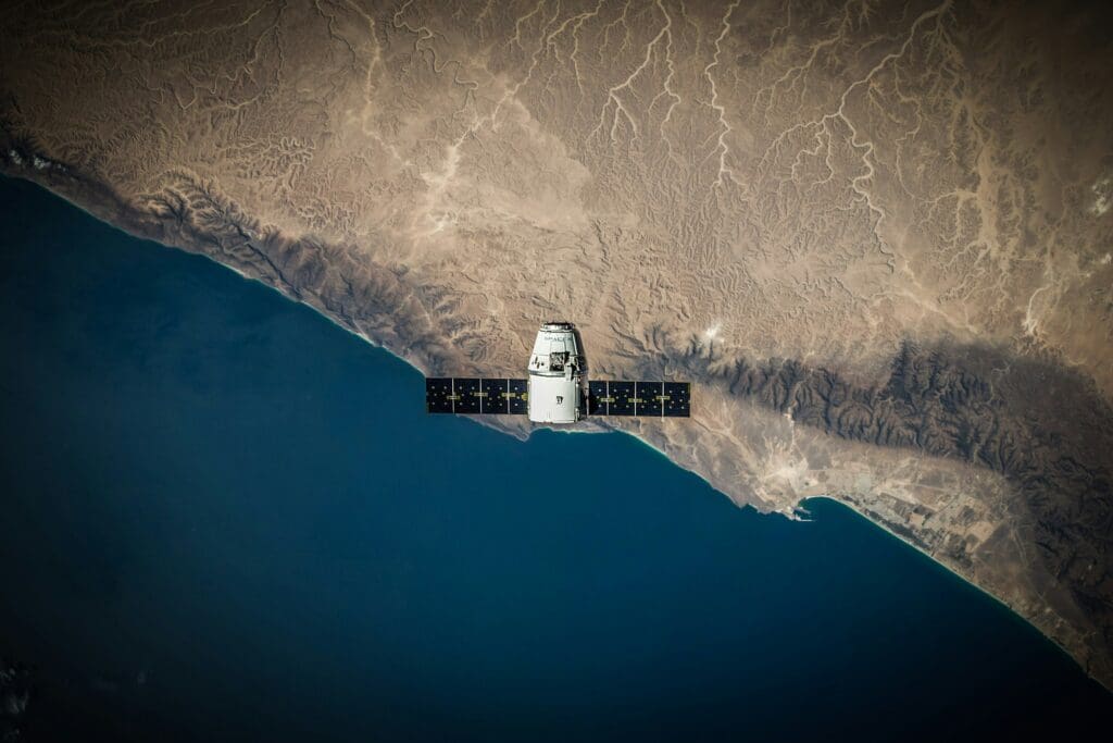 A space satellite hovering above a coastline; the biodiversity alert is based on their pictures