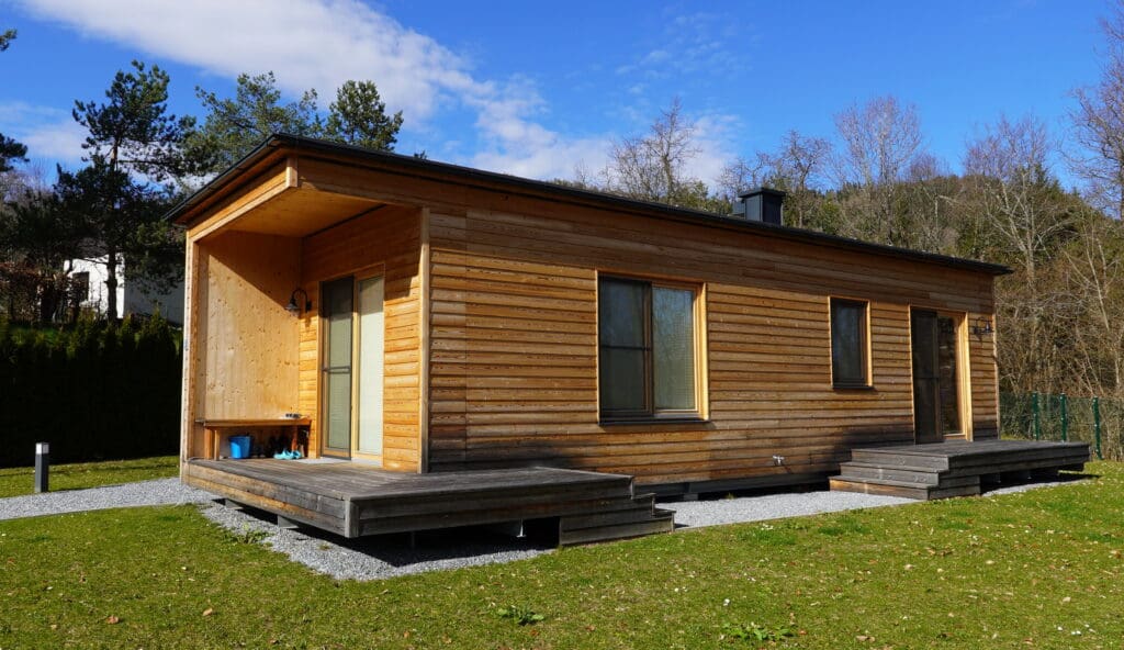 Tiny House aus Holz in Kasten-Form, versehen mit einer kleinen Veranda, in Kärnten, Österreich