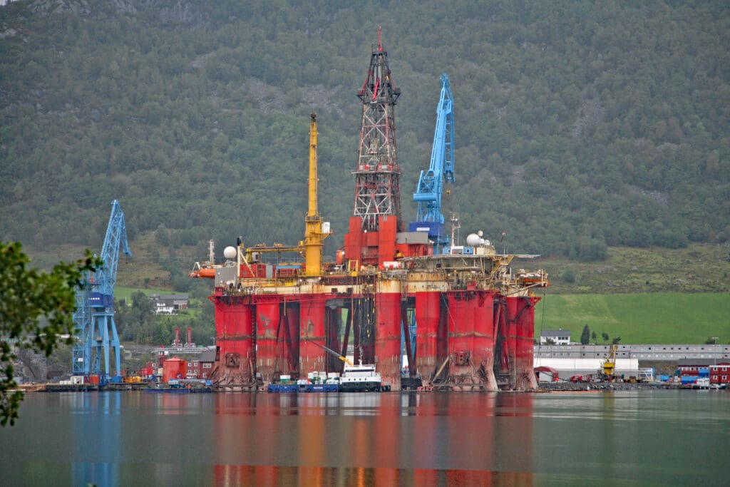 Norwegian oil and gas platform in a shipyard within a fjord
