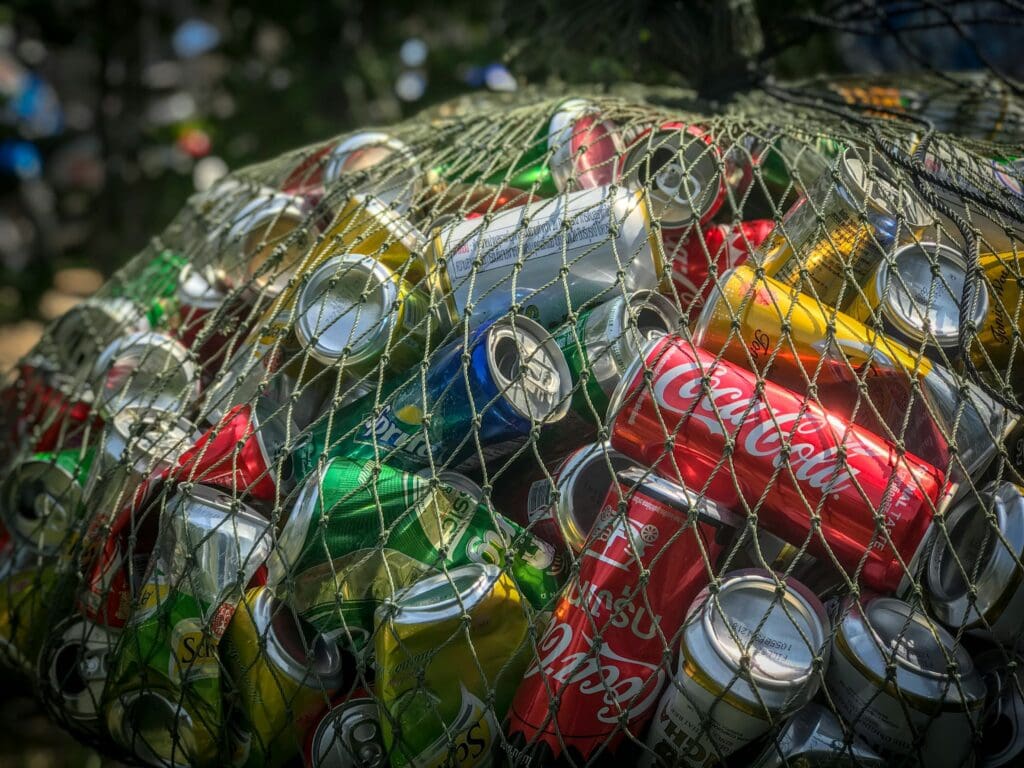A large net filled with aluminum cans, destined for recycling