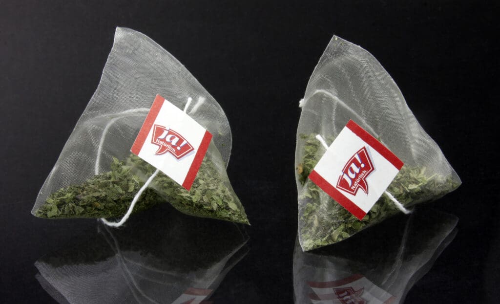 Two pyramid-shaped tea bags made from PLA fiber material