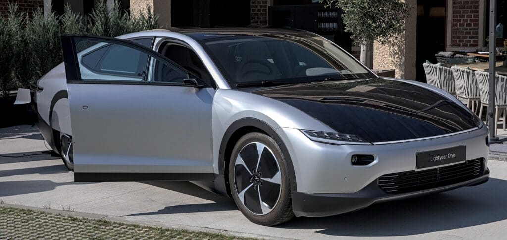 Silver EV covered with integrated solar cells on roof and bonnet