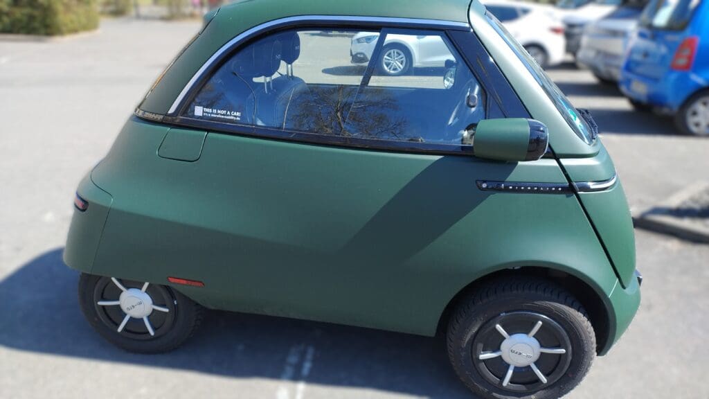Small green bubble EV on a parking lot